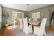 A dining room with a wood table, upholstered chairs, and natural light from the windows at 495 Heritage Way, Atlanta, GA 30328
