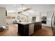 Open kitchen with hardwood floors, granite counters, stainless steel appliances, and views into the living area at 495 Heritage Way, Atlanta, GA 30328
