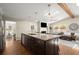 Open kitchen with hardwood floors, granite counters, stainless steel appliances, and views into the living area at 495 Heritage Way, Atlanta, GA 30328