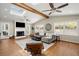 Cozy living room featuring vaulted ceiling, fireplace, hardwood floors, and comfortable seating area at 495 Heritage Way, Atlanta, GA 30328