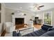 A bright living room with a fireplace, hardwood floors, and comfortable seating at 495 Heritage Way, Atlanta, GA 30328