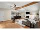 Bright open-concept living room featuring a fireplace, hardwood floors, and open access to the kitchen at 495 Heritage Way, Atlanta, GA 30328