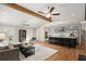 Open concept living room with hardwood floors, and kitchen island with barstool seating at 495 Heritage Way, Atlanta, GA 30328