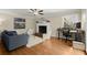 A bright living room with a fireplace, hardwood floors, and comfortable seating at 495 Heritage Way, Atlanta, GA 30328