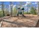 A playground is nestled in a wooded area, offering a fun and safe outdoor play space at 495 Heritage Way, Atlanta, GA 30328