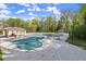 Large outdoor neighborhood pool with shade structures and a fence around it at 495 Heritage Way, Atlanta, GA 30328