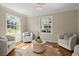 A cozy sitting area with hardwood floors, natural light, and comfortable seating at 495 Heritage Way, Atlanta, GA 30328