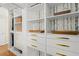 Bright walk-in closet boasts modern shelving and drawers with decorative wallpaper accent at 495 Heritage Way, Atlanta, GA 30328