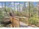 A wooden bridge spans a small creek, offering a charming and scenic element to the landscape at 495 Heritage Way, Atlanta, GA 30328