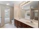 Bright bathroom features a double vanity, large mirror, and an open doorway to the next room at 923 Port West Dr, Auburn, GA 30011