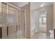 Clean bathroom with a glass enclosed shower, soaking tub, and an open doorway to the next room at 923 Port West Dr, Auburn, GA 30011