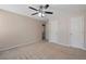 Neutral bedroom with carpet and standard ceiling fan with a view to the ensuite bathroom at 923 Port West Dr, Auburn, GA 30011