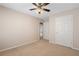 Neutral carpeted bedroom featuring two closets and standard ceiling fan at 923 Port West Dr, Auburn, GA 30011