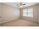 Neutral carpeted bedroom with standard ceiling fan and natural light from a window at 923 Port West Dr, Auburn, GA 30011