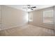 Neutral carpeted bedroom with standard ceiling fan and natural light from two windows at 923 Port West Dr, Auburn, GA 30011
