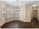 Bright breakfast nook featuring wood floors, pendant lighting, and multiple windows with shutter blinds at 923 Port West Dr, Auburn, GA 30011