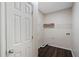 Compact laundry room offers shelving and wood-look tile flooring for easy maintenance at 923 Port West Dr, Auburn, GA 30011