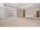 Spacious main bedroom featuring a tray ceiling, ceiling fan, and adjacent en suite bathroom at 923 Port West Dr, Auburn, GA 30011