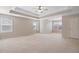 Expansive main bedroom with tray ceiling, ceiling fan, and multiple windows for natural light at 923 Port West Dr, Auburn, GA 30011
