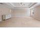 Bright and airy main bedroom with tray ceiling, ceiling fan, dresser, and ample space at 923 Port West Dr, Auburn, GA 30011