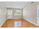 Bright bedroom with hardwood floors, large window, and access door leading to the backyard at 1531 Stone Gate Se Ln, Atlanta, GA 30317