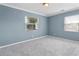 A sunlit bedroom with two windows, plush carpet, and freshly painted walls, offering a serene atmosphere at 1531 Stone Gate Se Ln, Atlanta, GA 30317