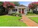 Charming home featuring a well-manicured lawn and vibrant red-flowered trees framing the entrance at 1531 Stone Gate Se Ln, Atlanta, GA 30317