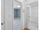 Bright hallway view showing bathroom and blue accent wall bedroom with plush carpet at 1531 Stone Gate Se Ln, Atlanta, GA 30317