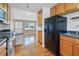 Bright, open kitchen features hardwood flooring, wooden cabinets, black appliances, and ample natural light at 1531 Stone Gate Se Ln, Atlanta, GA 30317