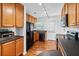 Efficient kitchen featuring plenty of wooden cabinets, black appliances, and bright overhead lighting at 1531 Stone Gate Se Ln, Atlanta, GA 30317