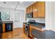 Well-equipped kitchen with natural wood cabinets, black appliances, and track lighting for ample illumination at 1531 Stone Gate Se Ln, Atlanta, GA 30317