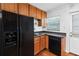 Kitchen with stainless steel appliances, wood cabinets, and a window offering natural light to the space at 1531 Stone Gate Se Ln, Atlanta, GA 30317
