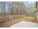 Fenced backyard with lawn, a concrete patio and an adjacent home exterior at 3443 Woodshade Dr, Loganville, GA 30052