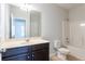 Bathroom featuring vanity with dark wood cabinets, white shower/tub, toilet, and a mirror at 3443 Woodshade Dr, Loganville, GA 30052