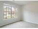 Bright bedroom with neutral carpet and paint. Large window provides a view at 3443 Woodshade Dr, Loganville, GA 30052