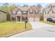 Charming two-story brick home with a well-manicured lawn and a two-car garage at 3443 Woodshade Dr, Loganville, GA 30052