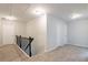 Upstairs hallway with carpeted floor, a dark wood banister, and two white doors at 3443 Woodshade Dr, Loganville, GA 30052