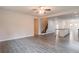 Open-concept living room with hardwood floors, neutral walls, and stairs to the upper level at 3443 Woodshade Dr, Loganville, GA 30052