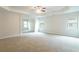 Spacious main bedroom with neutral carpet and paint with tray ceiling and windows with blinds at 3443 Woodshade Dr, Loganville, GA 30052