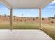 Covered back patio with concrete and a beautiful backyard view of grass and small shrubbery at 3720 Near Star Ln, Cumming, GA 30028