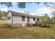 Exterior showcasing a well-maintained lawn, detached deck, and shed, perfect for outdoor enjoyment at 419 Fincher Rd, Covington, GA 30016