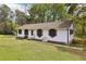 Exterior view of a one-story home with a large lawn, trampoline and swing at 419 Fincher Rd, Covington, GA 30016