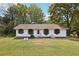 Charming one-story home featuring a manicured lawn and lovely curb appeal with a water fountain feature at 419 Fincher Rd, Covington, GA 30016