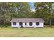 Charming one-story home featuring a manicured lawn and lovely curb appeal with a water fountain feature at 419 Fincher Rd, Covington, GA 30016