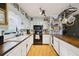 Kitchen with black appliances, white cabinets, wood countertops and a hanging pot rack at 419 Fincher Rd, Covington, GA 30016