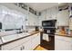 Kitchen featuring wood countertops, a black stove, white cabinets and a large window at 419 Fincher Rd, Covington, GA 30016