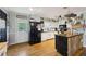Bright kitchen featuring white cabinets, an island, stainless appliances, and exterior access at 419 Fincher Rd, Covington, GA 30016