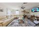 Cozy living room featuring a large leather sectional sofa, ceiling fan, and carpet flooring at 419 Fincher Rd, Covington, GA 30016