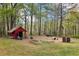 Outbuilding, boat, and doghouse on large lot with mature trees at 419 Fincher Rd, Covington, GA 30016
