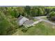 An aerial view of the home showing its placement on a large lot surrounded by mature trees and landscaping at 190 Ccc Rd, Kingston, GA 30145